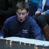 Senior class representative Duncan Maclachlan attempts to blow dry ice smoke onto the stage.