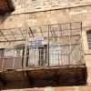A sign on a Palestinian balcony; photo taken from an Israeli-only street.