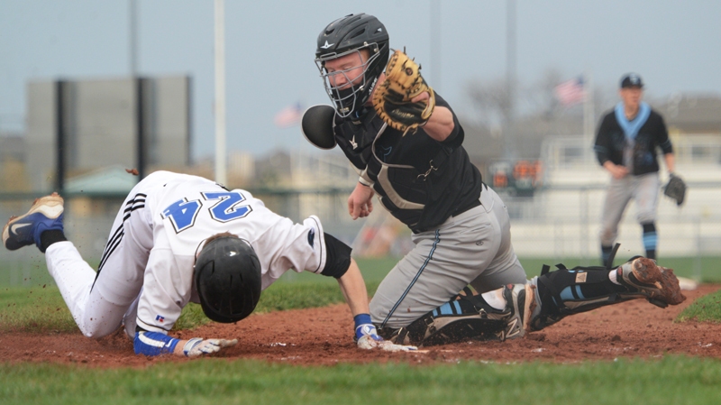 Junior Gunnar Troutwine tags out a player at home plate. photo by Jake Crandall