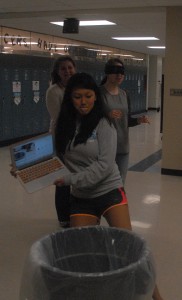 Senior Meili Estep kicks a trash can out of the way to prevent junior Katie Roe from tripping.  Photo by Kylie Schultz