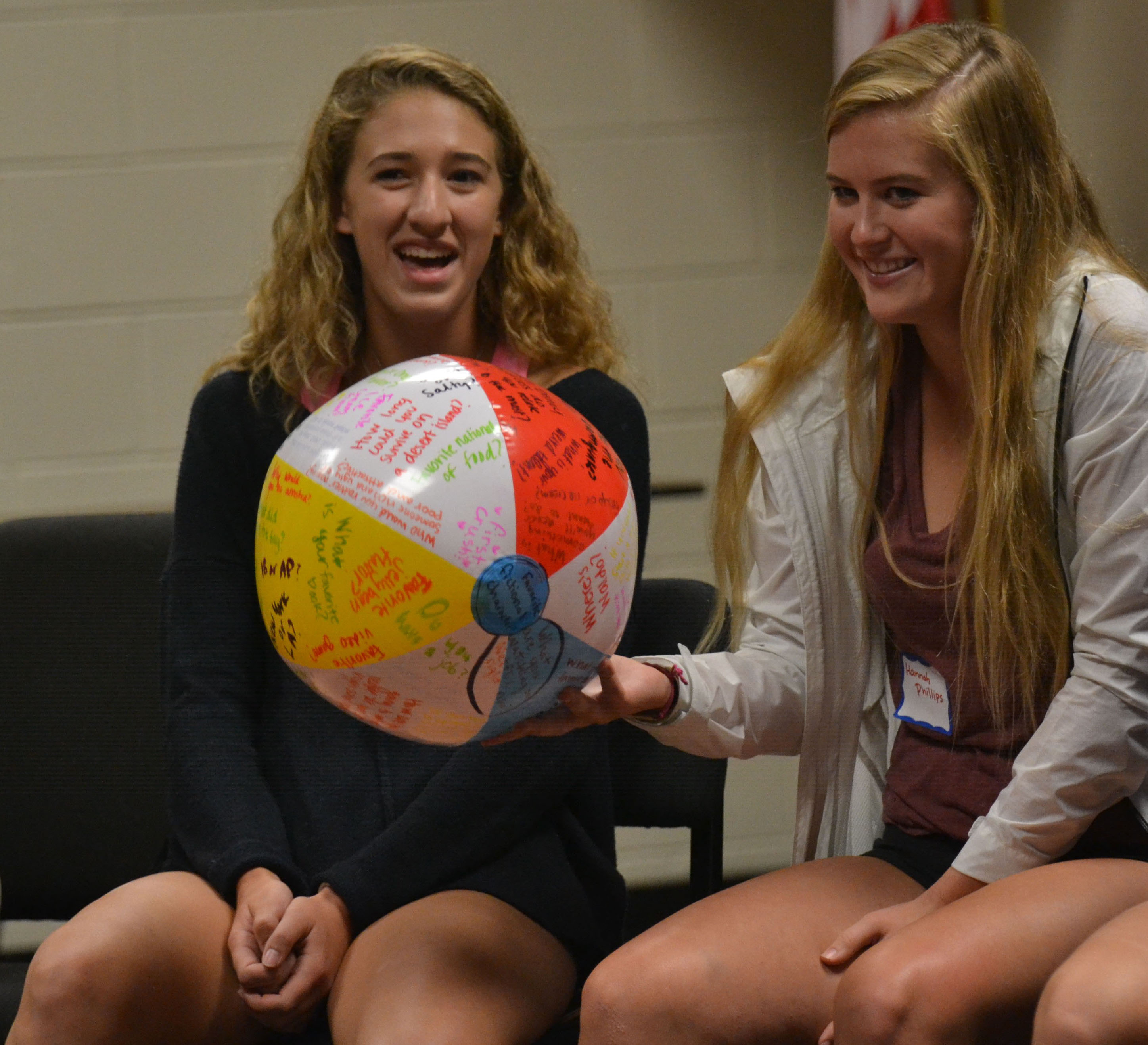 At the student council retreat, sophomores Olivia Caponecchi and Hannah  Phillips catch the ball, in a fun game of passing a ball around ina circle.  Photo by Morgan Plunkett | The Harbinger