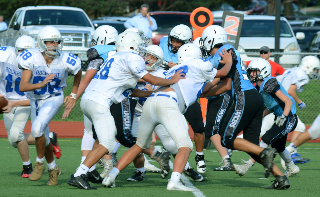 East freshman team sprints and tackles the Rockhurst players before they can run down the field for a touchdown. Photo by Grace Goldman