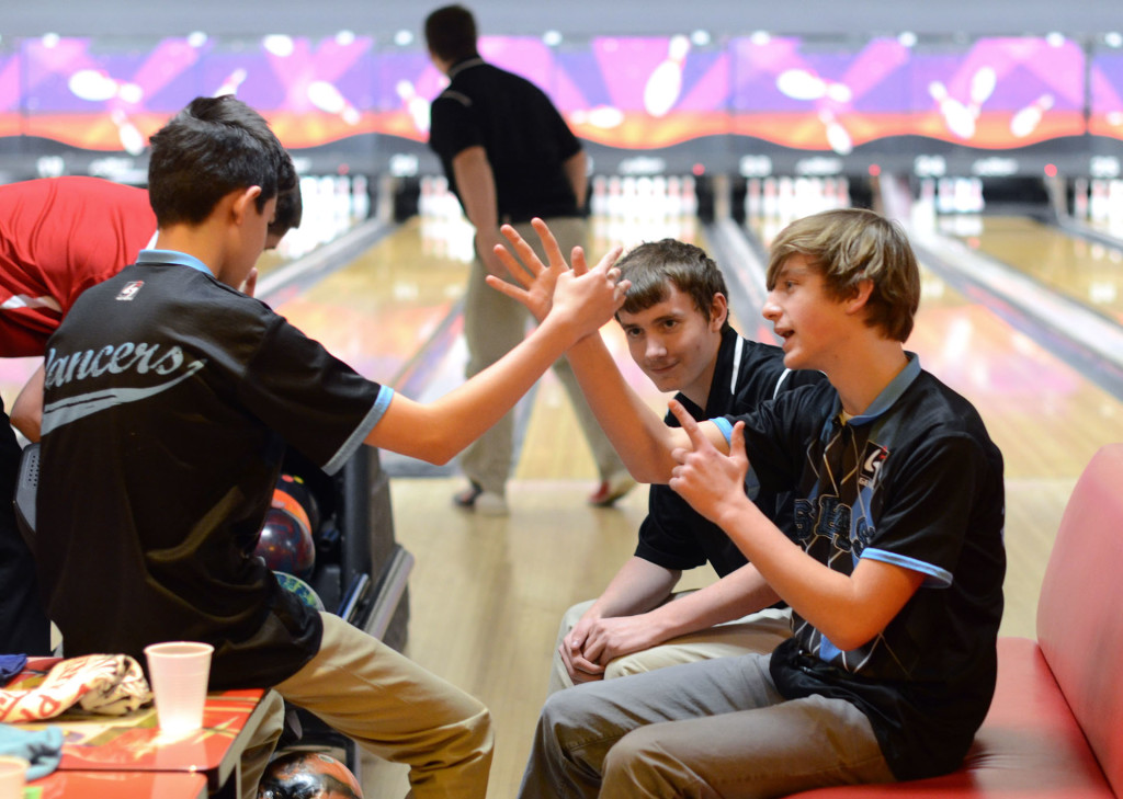 Waiting for his turn to bowl, sophomore Gray Warner makes up a handshake with one of his teammates. Photo by Grace Goldman