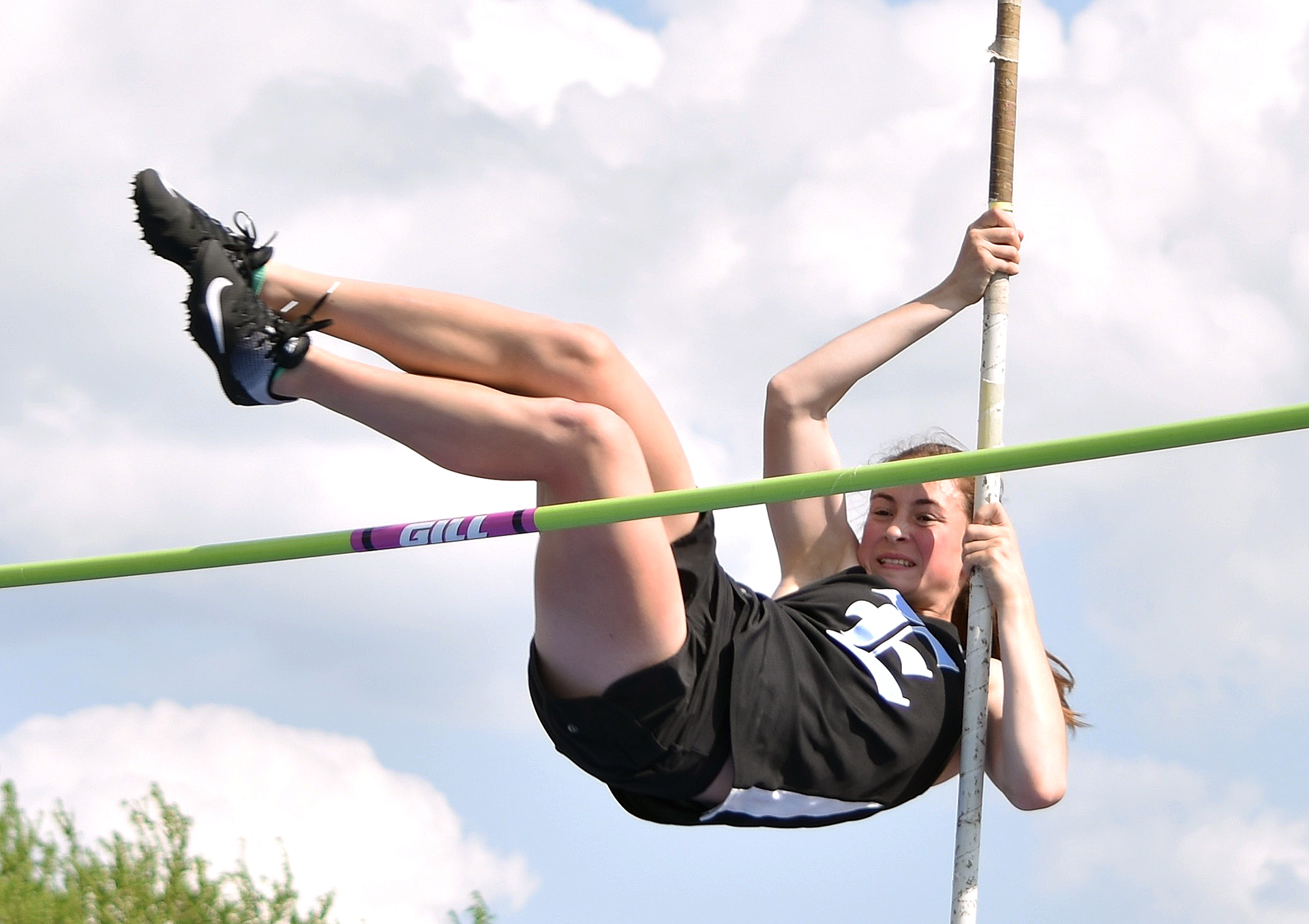 Freshman Brooklyn Beck pole vaults over the bar. Photo by Laini ...