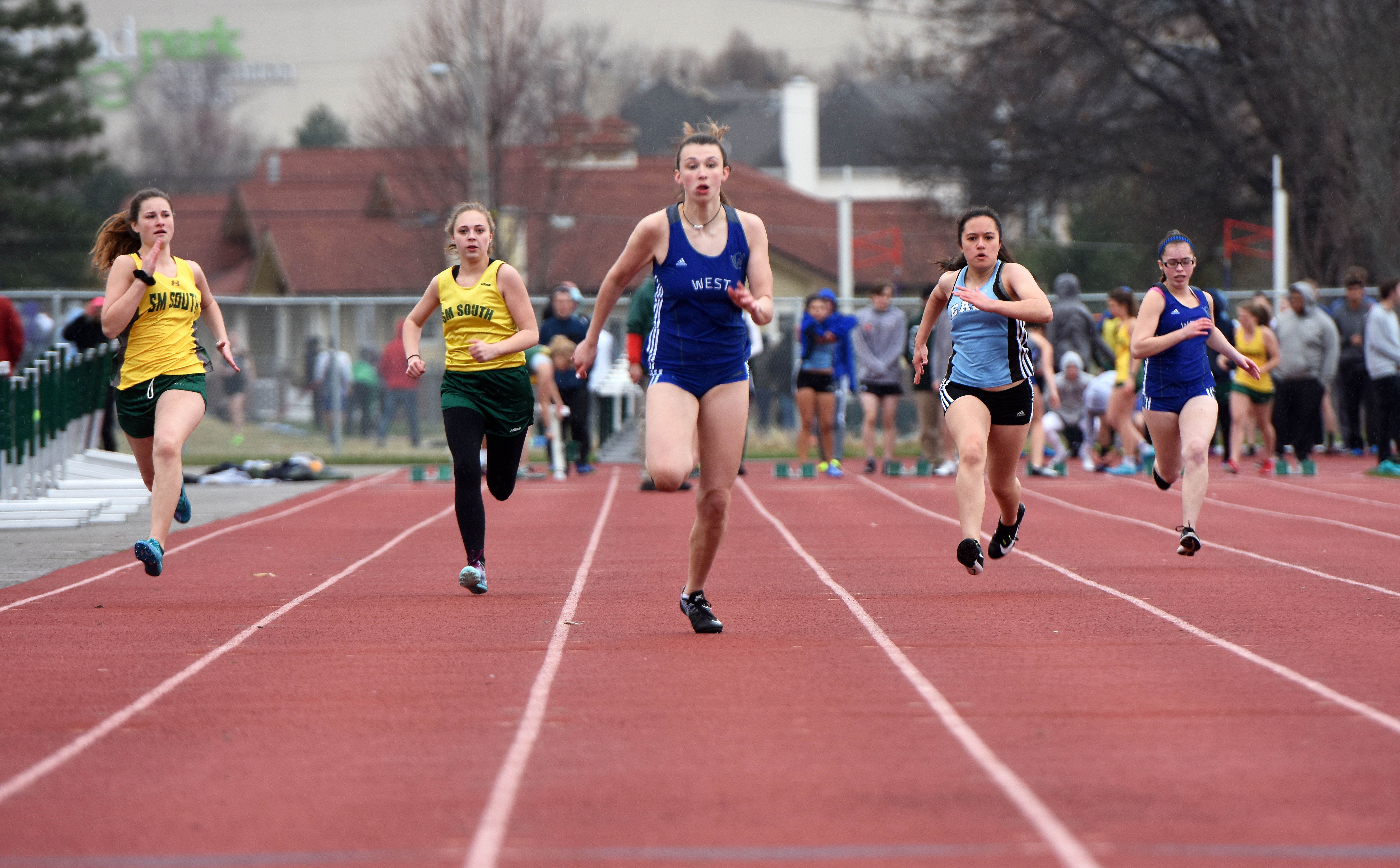 Girls in the 100 meter dash race to make it to the finish line first ...