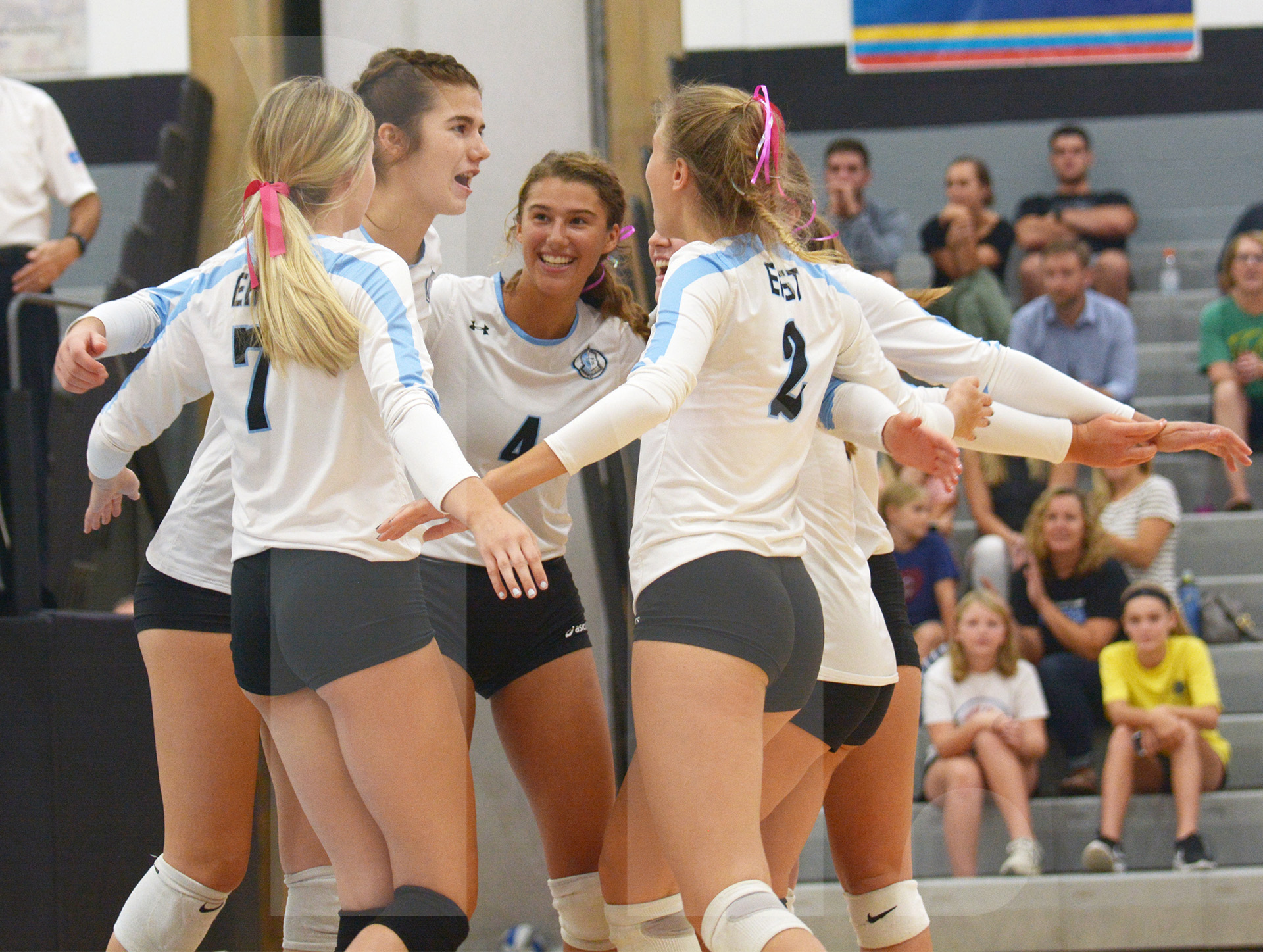 the-varsity-volleyball-team-huddles-together-in-excitement-after