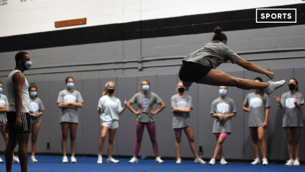 Pandemic Pep - The cheer team is prohibited from wearing masks while stunting